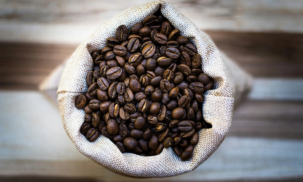 A bag of coffee beans sitting on top of a table.