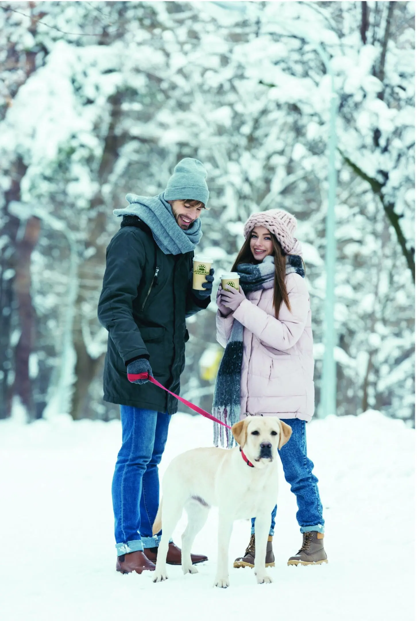 A man and woman standing next to each other in the snow.